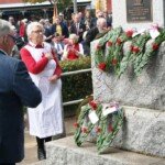 A representative of the Red Cross lays a wreath at the Creswick Cenotaph.