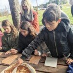 Students make clay handprints from clay gathered at Cornish Hill.