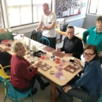 RDA Volunteers painting their Wombat Christmas Trees.
