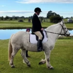 Adam successfully competing in his first dressage competition on a difficult borrowed horse.